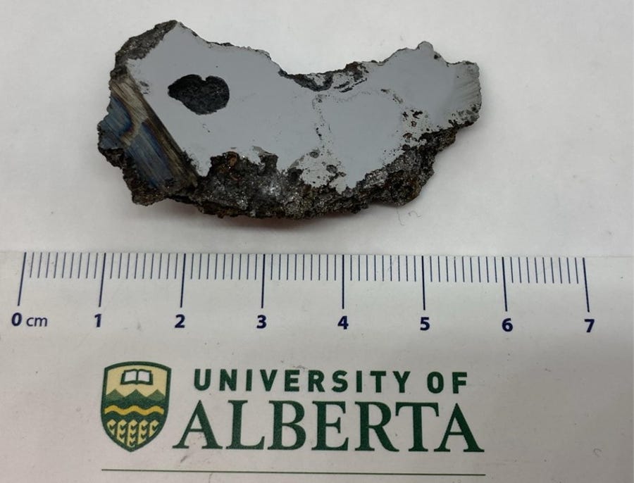 A piece of the meteorite containing two new discovered minerals.