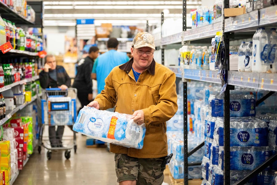 John Beezley, of Bonham, buys cases of water after learning that a boil water notice was issued for the entire city of Houston on Sunday, Nov. 27, 2022, at Walmart on S. Post Oak Road in Houston. Beezley just arrived in town with his wife, who is undergoing treatment starting tomorrow at M.D. Anderson Cancer Center, where they are staying in a camping trailer.