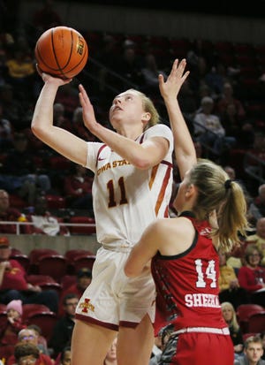 Iowa State's Emily Ryan (11) takes a shot over Southern Illinois' Sofie Lowis (24) during the second quarter at Hilton Coliseum on Tuesday.