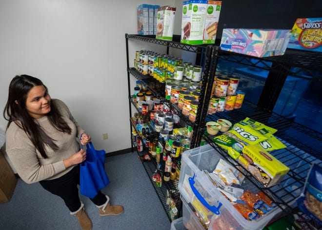 Student Pamela Delgado selects items from a food pantry at MATC's Walker Square campus, 816 W. National Ave., in Milwaukee The pantry opened Tuesday.