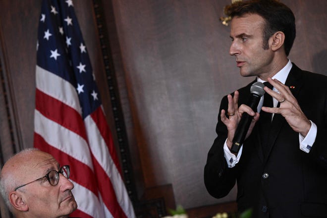 French President Emmanuel Macron speaks during a working lunch on climate and biodiversity issues with US Climate Envoy John Kerry, members of the United States Congress, and key US stakeholders on climate, at the Library of Congress in Washington, DC, on November 30, 2022.