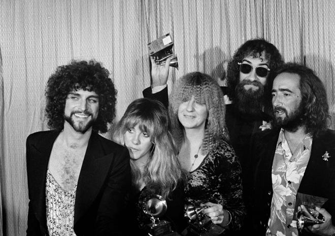 Members of Fleetwood Mac celebrate winning album of the year at the Grammy Awards "rumors" in Los Angeles on February 23, 1978. From left: Lindsey Buckingham, Stevie Nicks, Christine McVie, Mick Fleetwood and John McVie.