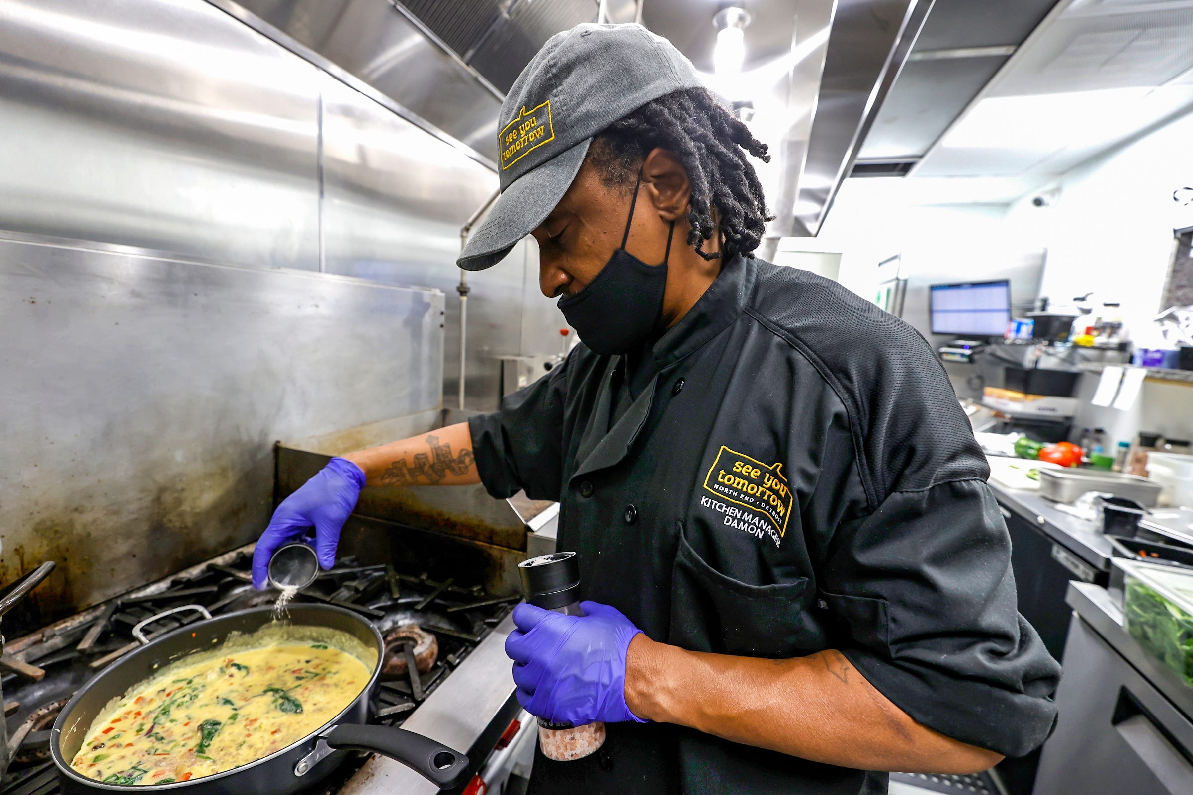 Damon Cann is the kitchen manager at See You Tomorrow, a restaurant on Woodward avenue in New Center Detroit, and works at scrambling eggs before they open at 8 a.m. on Wed., Nov 30, 2022.
Cann was a cook at a Birmingham restaurant before coming to work at See You Tomorrow, not far from where he grew up.