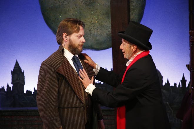 Douglas Landin as Bob Cratchit and Brad Wages as Ebenezer Scrooge in the 2022 production of Venice Theatre’s musical “A Christmas Carol.”
