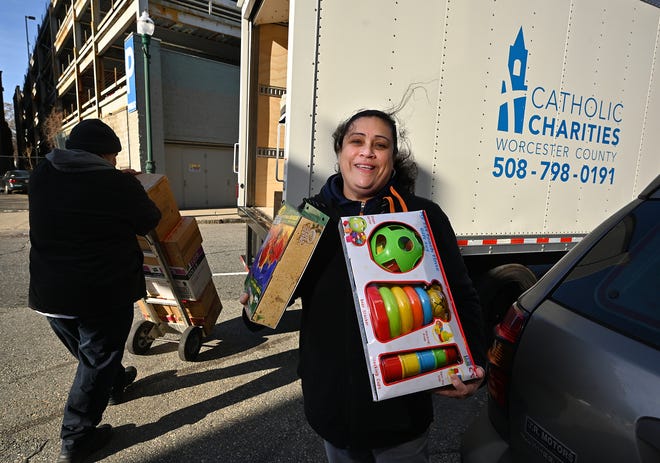 Maritza Delacruz, with the Catholic Charities of Worcester County, picks up the gifts from the Salvation Army to be distributed to kids as part of the T&G Santa Fund.