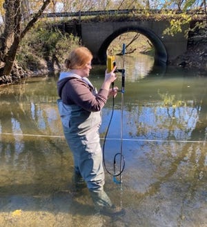 A student from Youngstown State University gathers flow data to develop a model to investigate nutrient and sediment sources in Atwood Lake and Tappan Lake watersheds. The university, using a grant from the Muskingum Watershed Conservancy District, partnered with the Harrison and Carroll Soil and Water Conservation District to do the study.