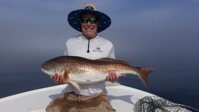 Matt Williams of Woodstock, Ga. with a 39 inch 26.8 pound redfish caught while fishing with Capt. Pat McGriff.