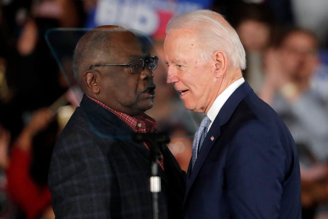 Then-Democratic presidential candidate Joe Biden talks to Rep. James Clyburn, D-S.C., at a primary night election rally in Columbia, S.C., Feb. 29, 2020 after winning the South Carolina primary.