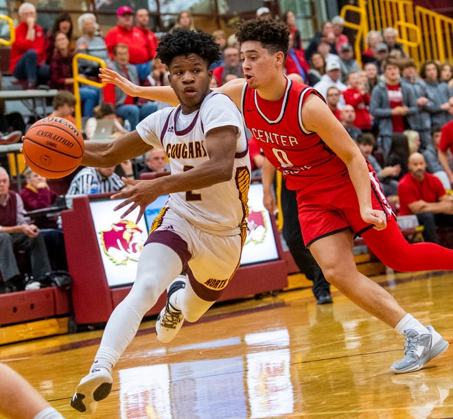 Bloomington North's Dawan Daniels (2) drives past Center Grove's Jalen Bundy (0) during the Bloomington North versus Center Grove boys basketball game at Bloomington High School North on Friday, Dec. 2, 2022.