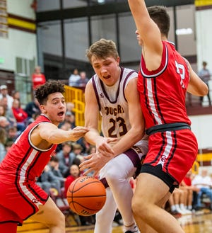 Bloomington North's Gavin Reed (23) is stripped by Center Grove's Jalen Bundy while being guarded by Will Spellman (42) during the Bloomington North versus Center Grove boys basketball game at Bloomington High School North on Friday, Dec. 2, 2022.