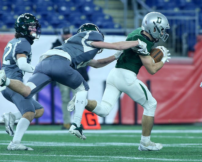 Duxbury's Dylan DeAngelis looks to escape the tackle of Grafton's Nick St. George after making a catch on a deep ball during second quarter action of their game against Grafton in the Division 4 Super Bowl at Gillette Stadium in Foxborough on Friday, Dec.  2, 2022. 