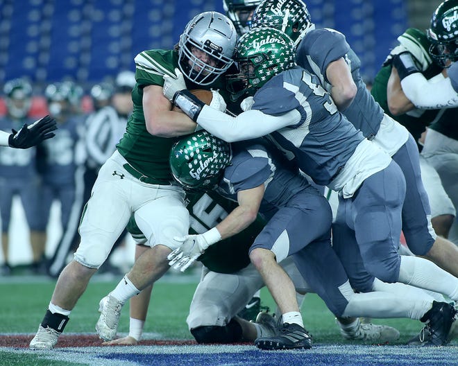 Duxbury's Alexander Barlow churns his legs while being tackled by Grafton's Cooper Berube during second quarter action of their game against Grafton in the Division 4 Super Bowl at Gillette Stadium in Foxborough on Friday, Dec.  2, 2022. 