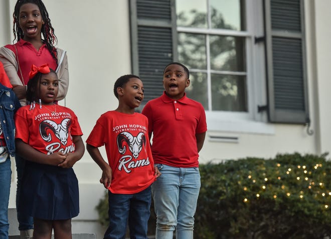 The choir from John Hopkins Elementary School sings during Visit Jackson's 'Capital City Lights' holiday tree lighting ceremony at City Hall in Jackson, Miss., Friday, December 2, 2022.