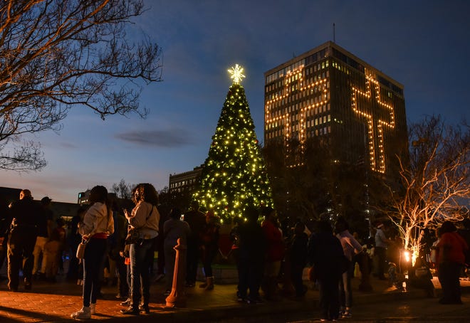 A Christmas tree at Jackson's City Hall is seen in front of downtown's Capitol Towers during Visit Jackson's 'Capital City Lights' holiday tree lighting ceremony at City Hall in Jackson, Miss., Friday, December 2, 2022.
