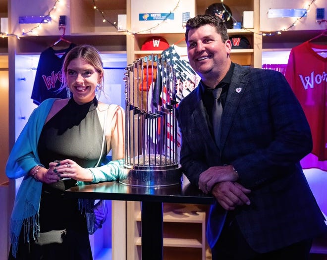 Former Boston Red Sox closer and World Series hero Keith Foulke poses with the 2004 World Series trophy and an attendee at the WooSox Foundation Gala last week in Worcester.