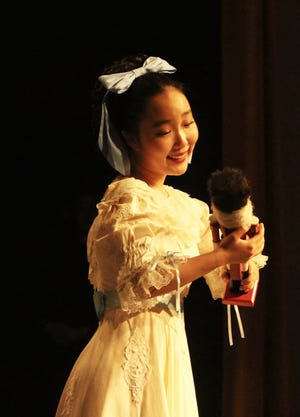 Clara holds the nutcracker doll during Montgomery Ballet's "Nutcracker" performance from last year.