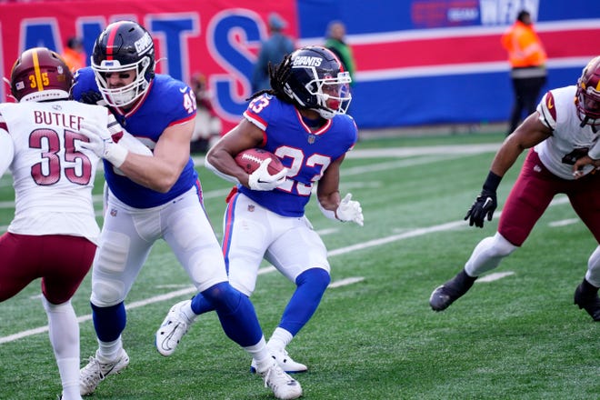 Dec 4, 2022; East Rutherford, NJ, USA;  New York Giants running back Gary Brightwell (23) runs against the Commanders. Mandatory Credit: Kevin Wexler-The Record