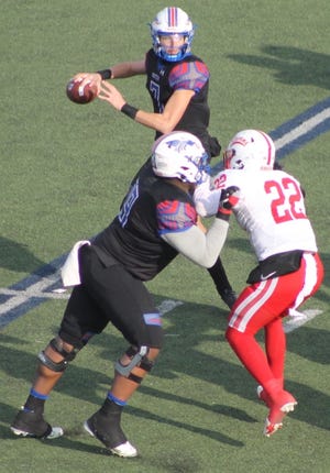 Hutchinson Community College sophomore quarterback Dylan Laible (7) drops back to pass in Saturday’s NJCAA national semifinal game at Gowans Stadium as HCC sophomore offensive lineman Brandon Hall (69) blocks Coffevyville’s Kalil Alexander (22).  Laible completed 14-of-24 passes for 171 yards and two touchdown passes to lead the Blue Dragons to a 38-7 win over the Red Ravens. No. 1 ranked HCC (11-0) advanced to the NJCAA national championship game Dec. 14 at War Memorial Stadium in Little Rock, Ark.