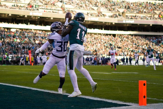 Philadelphia Eagles' A.J. Brown scores a touchdown in front of Tennessee Titans' Tre Avery during the second half of an NFL football game, Sunday, Dec. 4, 2022, in Philadelphia. (AP Photo/Matt Slocum)