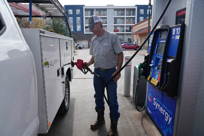 Rob Murray fills up his truck at a gas station in Austin on Dec. 5. The average price for a gallon of unleaded gasoline in Austin is $2.72, up 14 cents from a month ago.