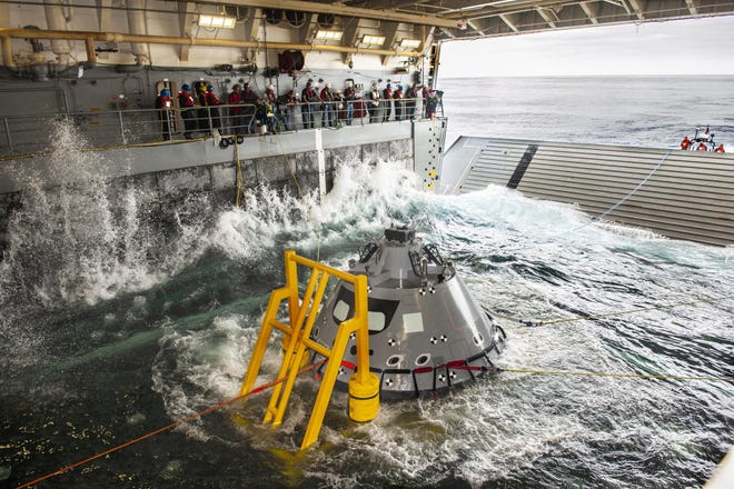 A test version of the Orion capsule is pulled into the flooded well deck of the USS John P. Murtha during an October 2018 NASA splashdown exercise in the Pacific Ocean.