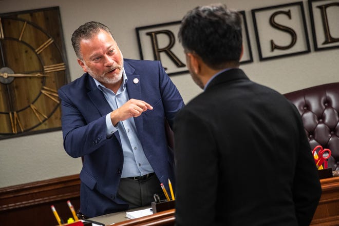 Robstown ISD Superintendent Jose Moreno speaks with Tesla Senior Global Director Rohan Patel after the board voted to approve a Chapter 313 tax incentive package for a new Tesla lithium refining facility during a meeting at the district office on Monday, Dec. 5, 2022, in Robstown, Texas.