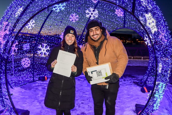 A Wello staff member and intern collect responses to the Wintermission survey at the 2022 Frenzy on the Fox in Green Bay.