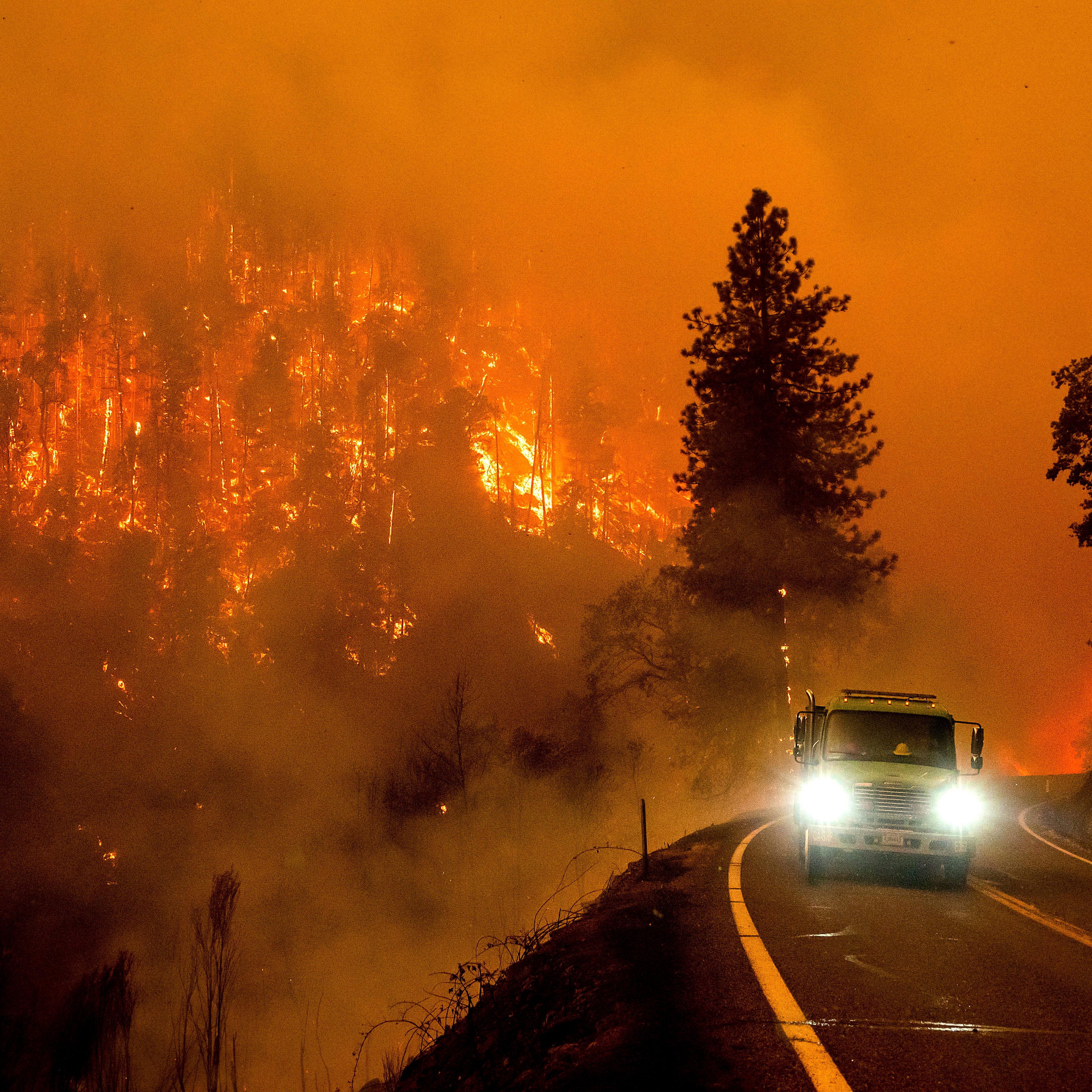 July 30, 2022: A firetruck drives along California Highway 96 as the McKinney Fire burns in Klamath National Forest, Calif.