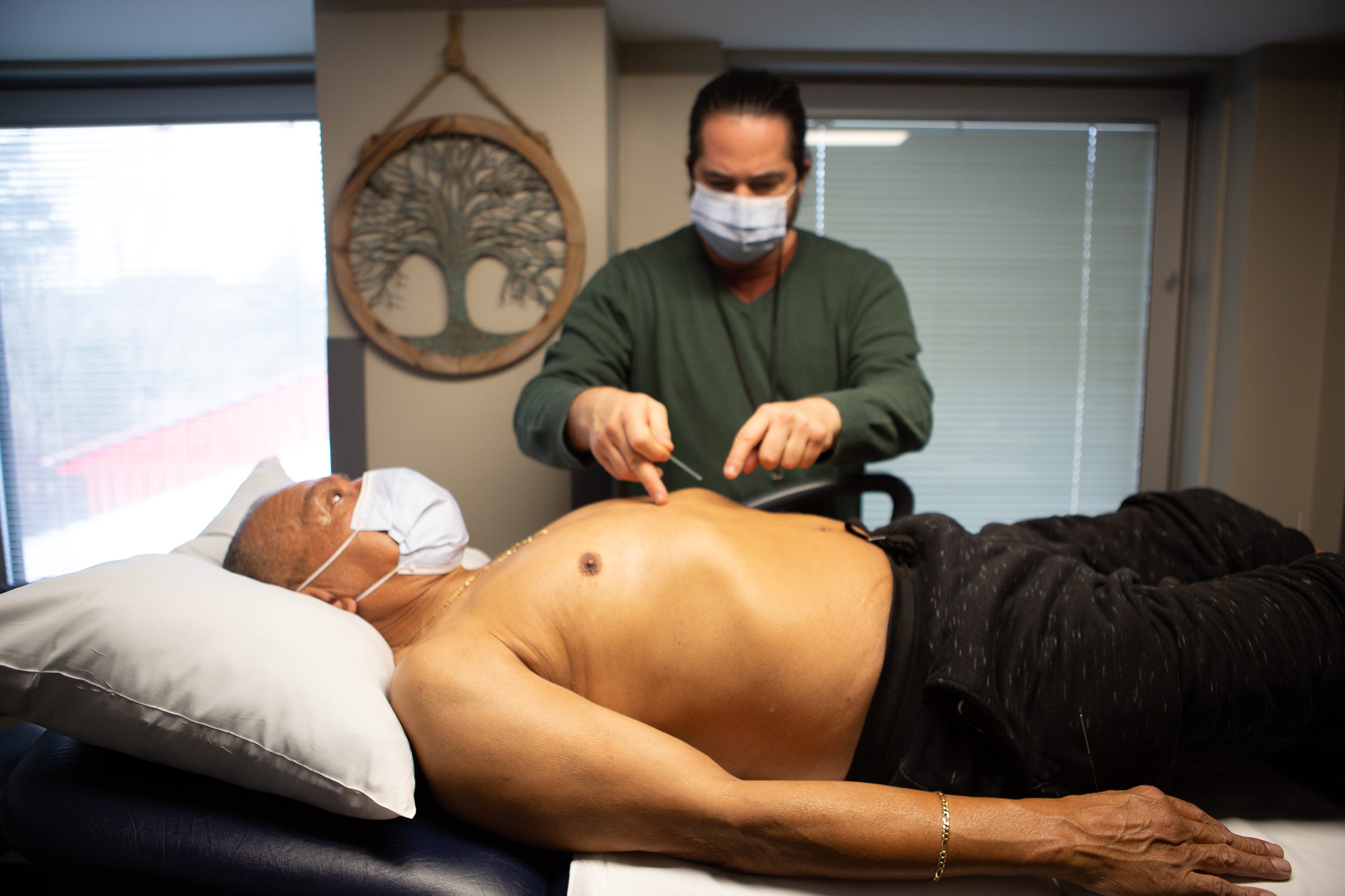 Dr. Alfred "Fred" Russo,  from Philadelphia, who has practiced at the VA  Medical Center in Beckley for 2 years administers acupuncture to James H. Mitchell, Sr.., 67-years-old,  an Army veteran on Monday December 5 at 9:30 a.m.., following Mitchell's 9:00 yoga class with recreational therapist, Lydia Cox. Mitchell said five years ago he could barely walk and didn't want to endure nerve surgery on his back, so he chose to try alternative practices that he claims have changed his life for the better. 