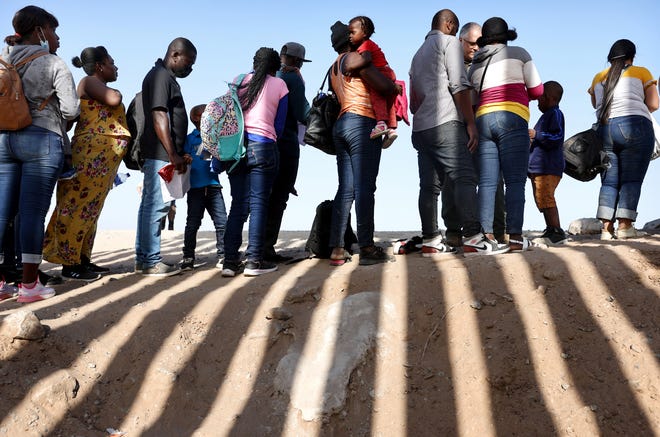May 20, 2022: Immigrants from Haiti, who crossed through a gap in the U.S.-Mexico border barrier, wait in line to be processed by the U.S. Border Patrol in Yuma, Arizona. Title 42, the controversial pandemic-era border policy enacted by former President Trump, which cites COVID-19 as the reason to rapidly expel asylum seekers at the U.S. border, was set to expire on May 23. But, a federal judge in Louisiana delivered a ruling blocking the Biden administration from lifting Title 42.