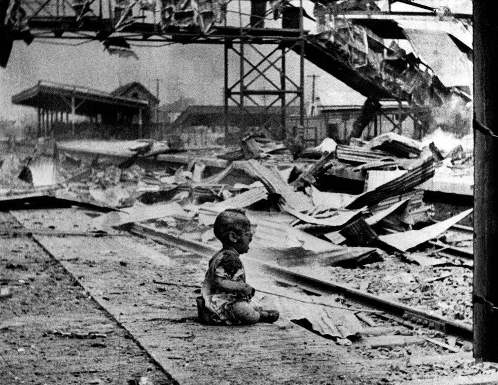 A bloodied child cries in the ruins of a railway station in Shanghai, China, after a Japanese bombing in 1937.