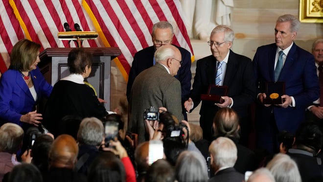 Charles and Gladys Sicknick, father and mother of slain U.S. Capitol Police Officer Brian Sicknick, are greeted by Senate Majority Leader Chuck Schumer of N.Y., center, with Senate Minority Leader Mitch McConnell of Ky., and House Minority Leader Kevin McCarthy of Calif., at right, during a Congressional Gold Medal ceremony honoring law enforcement officers who defended the U.S. Capitol on Jan. 6, 2021, in the U.S. Capitol Rotunda in Washington, Tuesday, Dec. 6, 2022.