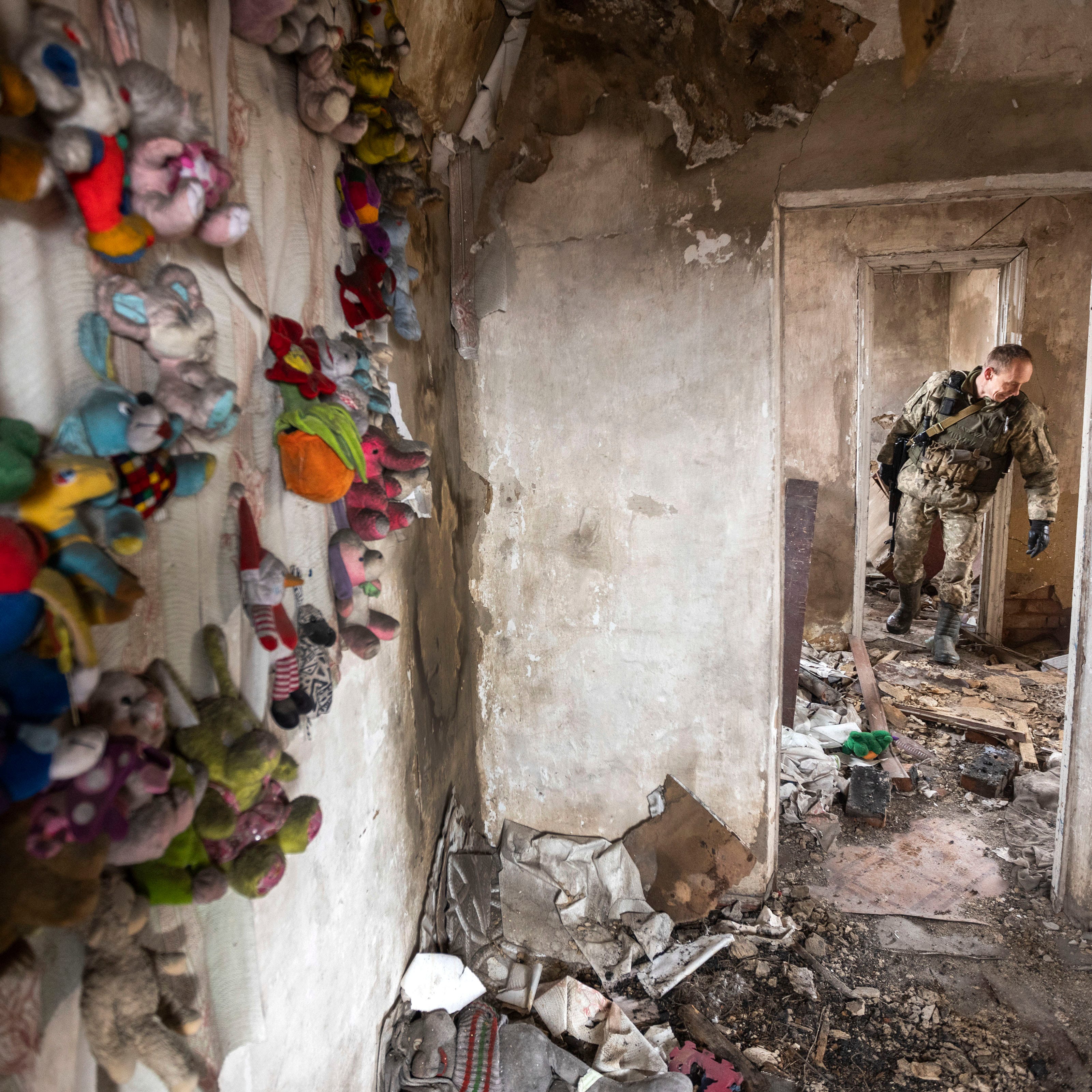 January 9, 2022: A Ukrainian soldier walks through the abandoned house at a line of separation from pro-Russian rebels, Donetsk region, Ukraine.