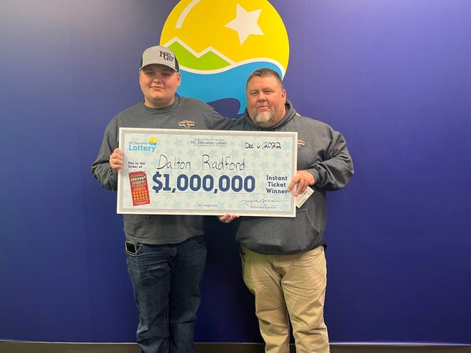 Dalton Radford of Dallas, left, poses for a photograph with his father, Tim Radford, after winning $1 million in a scratch-off game with the North Carolina Education Lottery.