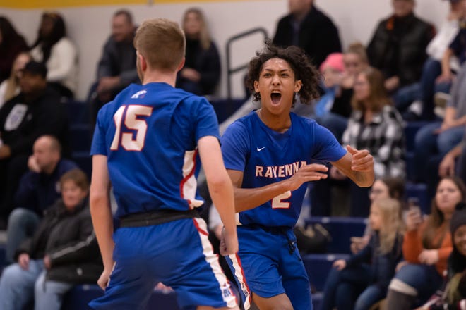 Ravenna senior guard Maykai O’Neal reacts to senior guard Marcus Gibson’s 3-pointer at the end of the third quarter to put the Ravens in the lead over Streetsboro during Tuesday night’s basketball game.