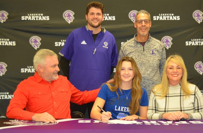 Lakeview senior diver Bradleigh Palmer commits to join the Grand Valley State University women's swimming and diving team during a signing ceremony at Lakeview High School on Wednesday. She is joined by her parents and Lakeview coaches.