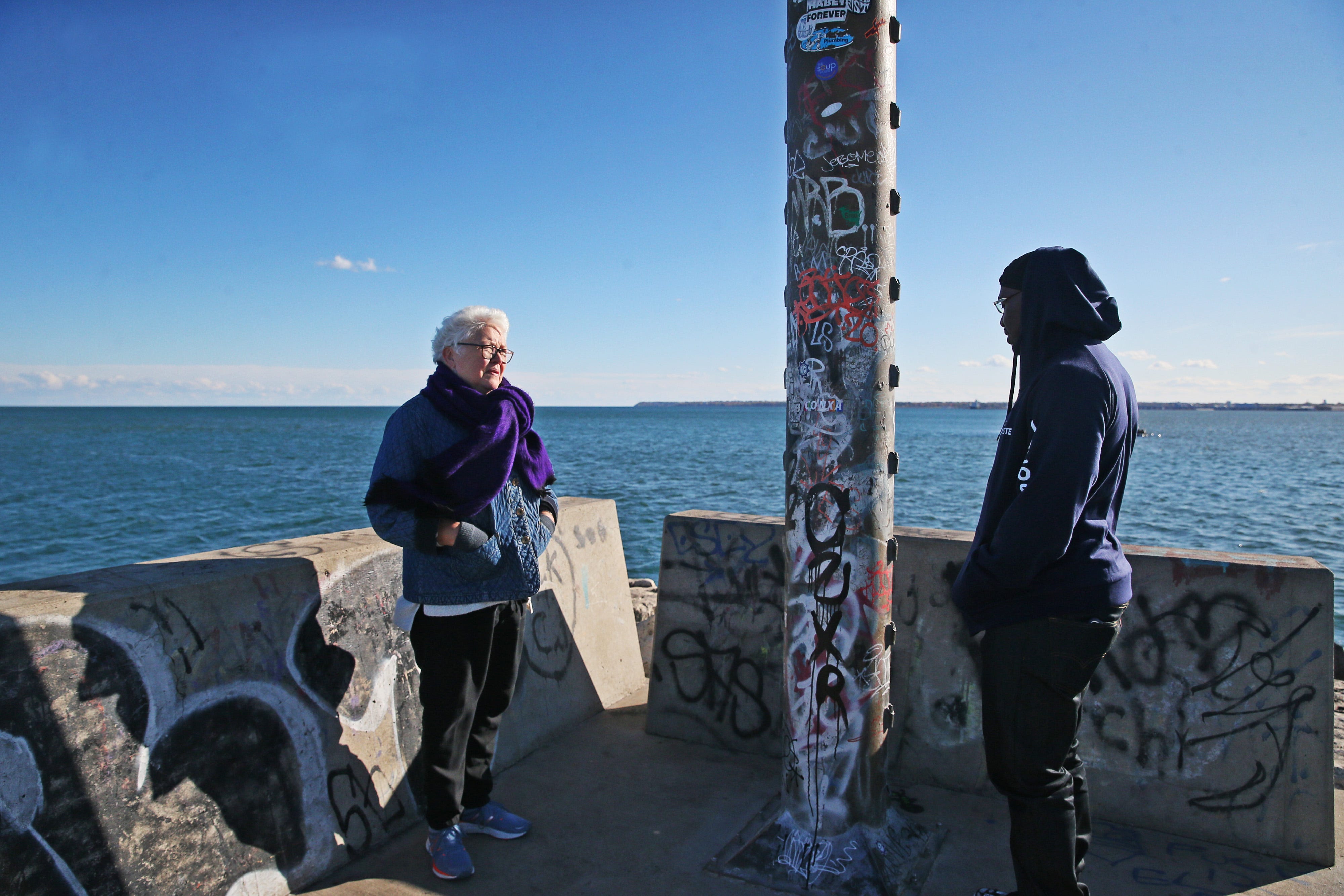 Vicki Conte, left, visits with Marlin Dixon on the Milwaukee lakefront shortly after his release from prison. Conte befriended Marlin while he was incarcerated and continued encouraging him as he transitioned back into society.