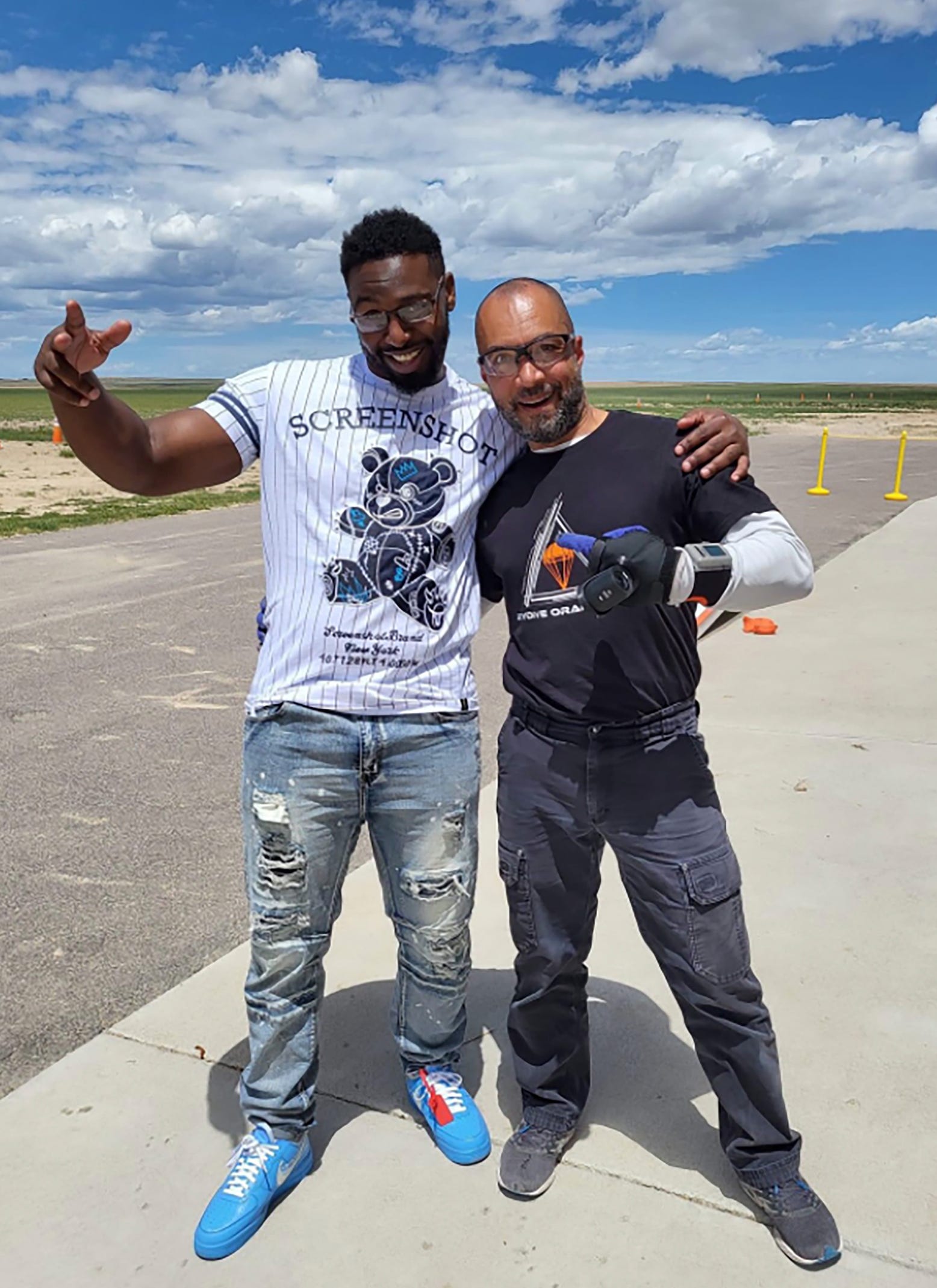 Marlin Dixon, left, poses with his skydiving instructor after jumping from a plane in Colorado in June. Dixon who went to Denver to visit Vicki Conte, his friend and supporter.