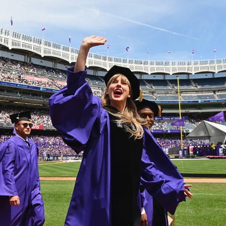 Singer Taylor Swift waves at graduating students during New York University's commencement ceremony for the class of 2022, at Yankee Stadium in New York City on May 18, 2022. - Swift, who received an honorary doctorate of fine arts, is the commencement speaker. (Photo by Angela Weiss / AFP) (Photo by ANGELA WEISS/AFP via Getty Images) ORG XMIT: 0 ORIG FILE ID: AFP_32AD9GV.jpg