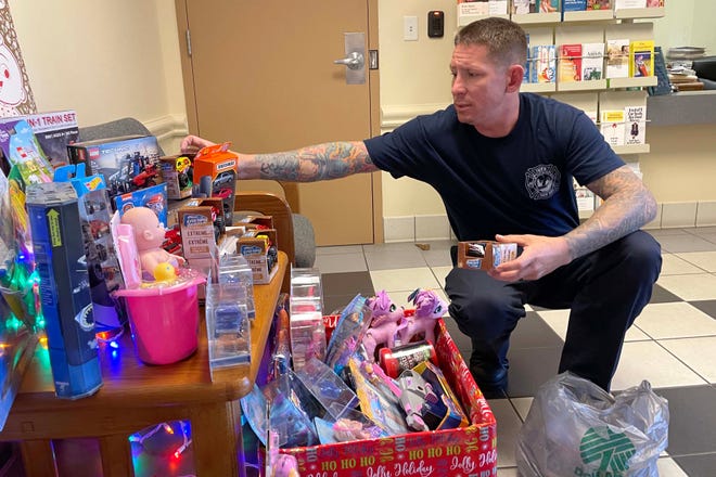 James Freudenberg with the Fort Walton Beach Fire Department arranges some of the toys collected through the firefighters' toy drive in the lobby of the Hollywood Boulevard fire station. The firefighters' annual toy drive is in full swing, with two "cruz thru the firehouse" events scheduled for Saturday and again on Dec. 17.