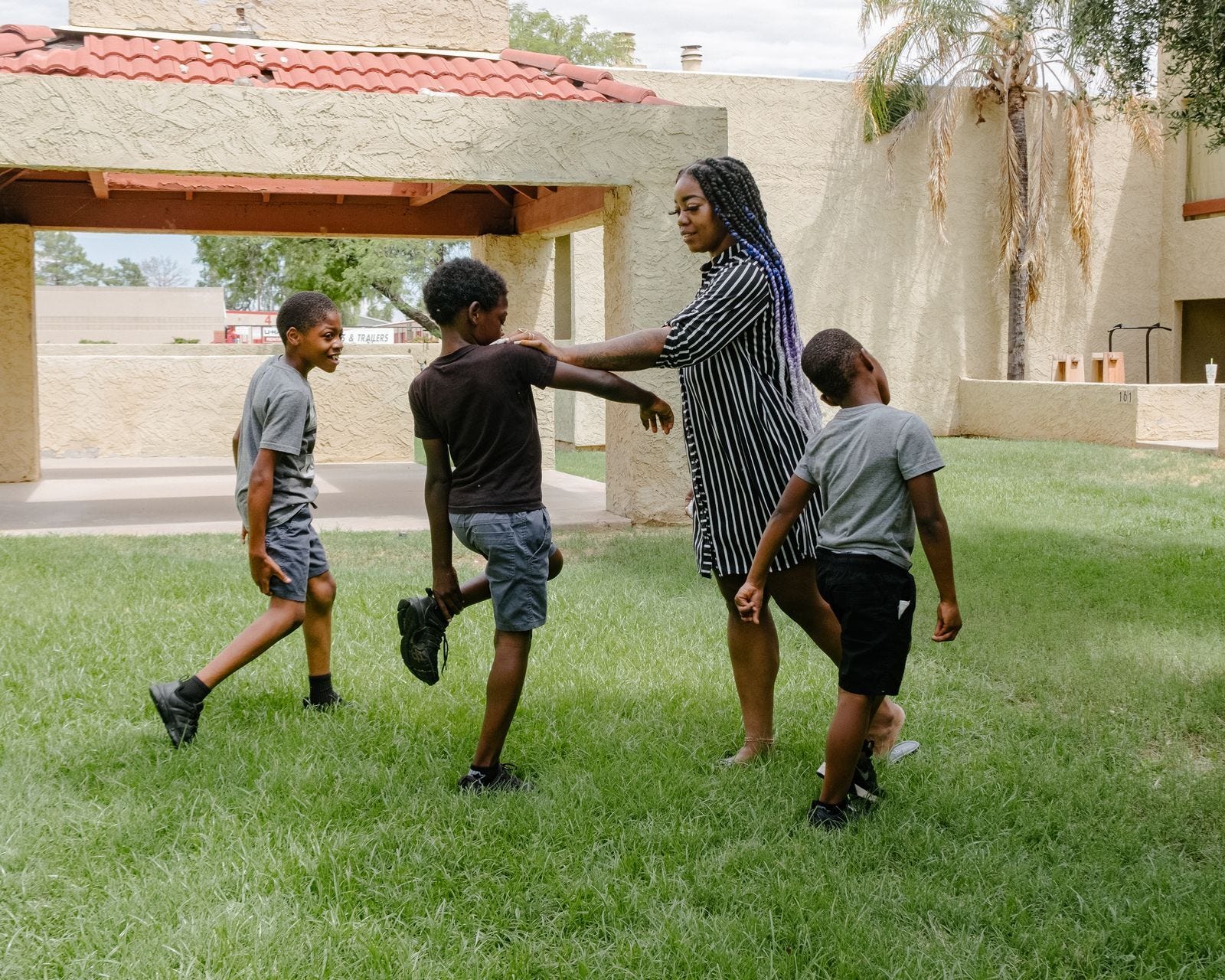 Tyra Smith with three of her sons at their apartment complex in suburban Mesa.