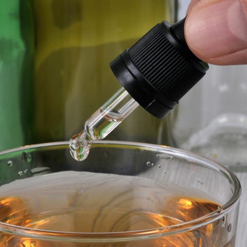 Concept of pouring GHB into a glass with a pipette