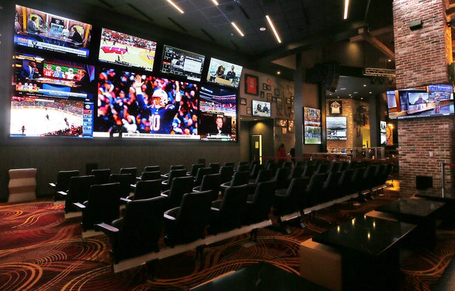 The new sportsbook area at MGM Northfield includes stadium seating and a mega-sized screen.