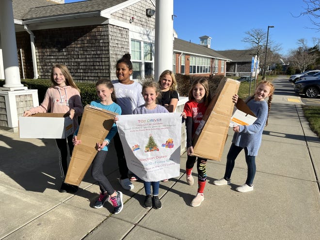 Fourth-graders at Chatham Elementary School set up boxes and a poster for their student-led toy drive.