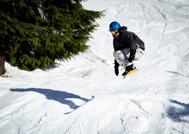 A snowboarder leaps off a jump at Willamette Pass Resort Wednesday, Dec. 7, 2022.