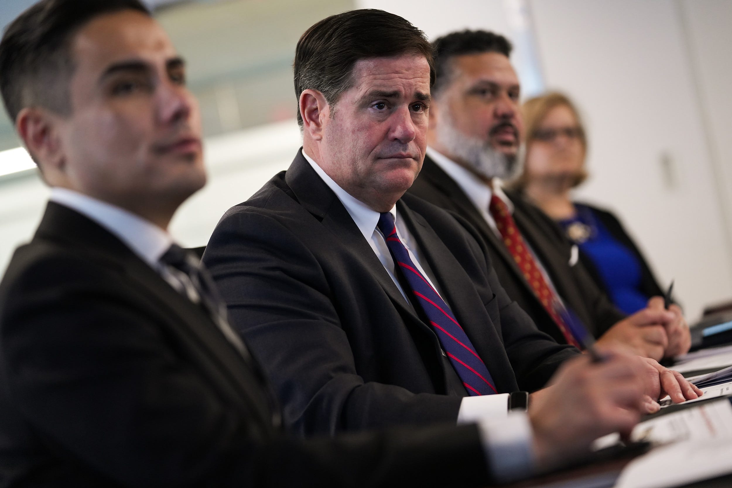 Gov. Doug Ducey listens to presentations from various Arizona agency directors during his last cabinet meeting as governor on Dec. 8, 2022, in Phoenix.