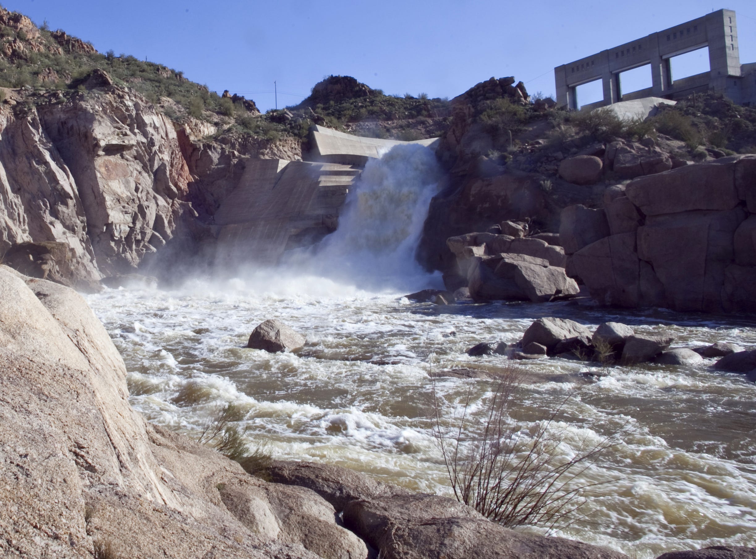 Water flows into the Verde River below Bartlett Dam in this photo from 2010. Salt River Project is studying a plan to raise the height of the dam to increase water storage.