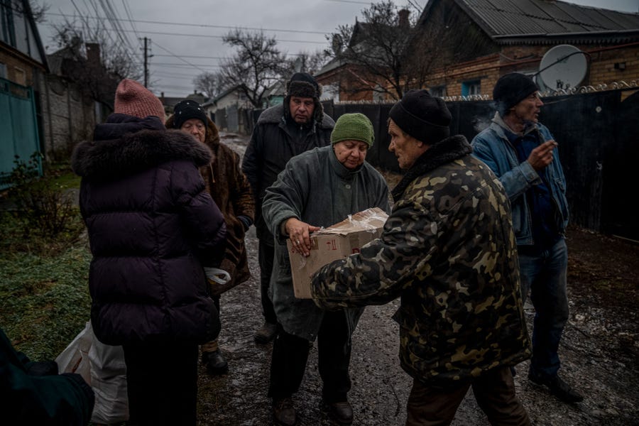 Locals receive humanitarian aid in Bakhmut, Donetsk region on December 8, 2022, amid the Russian invasion of Ukraine.