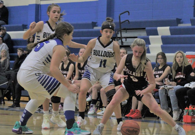 Inland Lakes' Natalie Wandrie (15), Tara Clancy (4) and Hannah Robinson (11) swarm Bellaire guard Alayna Elandt (5) during the first half of a girls basketball contest at Inland Lakes on Friday.