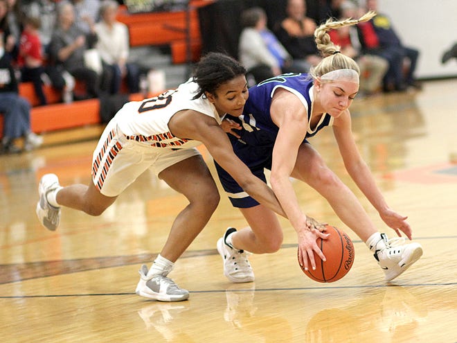 Keyanna O'Tey of Sturgis and Mackenzie Topp of Plainwell battle for a loose ball in prep hoops action on Friday.
